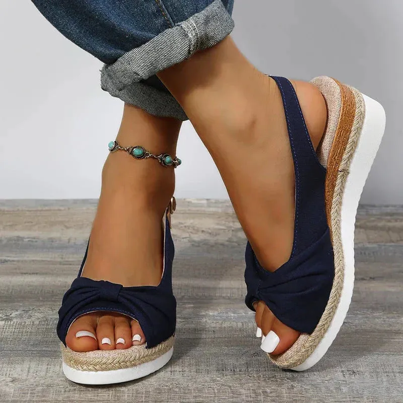 Stylish summer espadrille sandals featuring a buckle and knot accent.