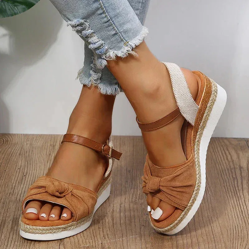 Stylish summer espadrille sandals featuring a buckle and knot accent.