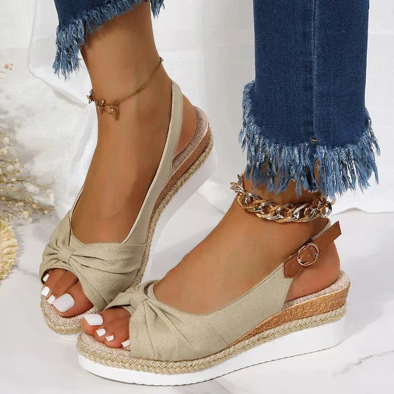 Stylish summer espadrille sandals featuring a buckle and knot accent.