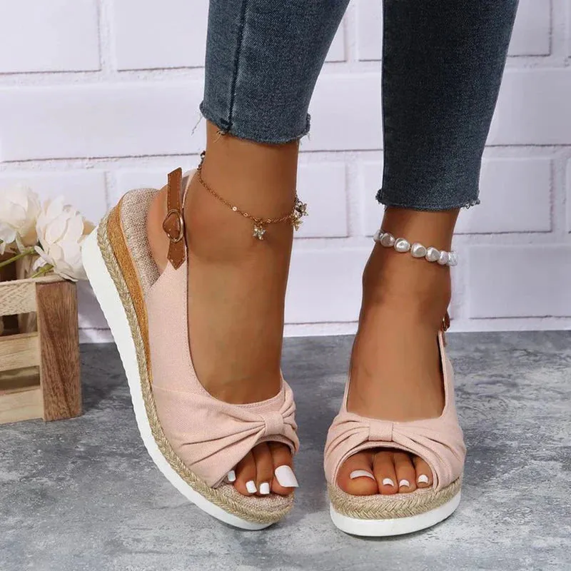 Stylish summer espadrille sandals featuring a buckle and knot accent.